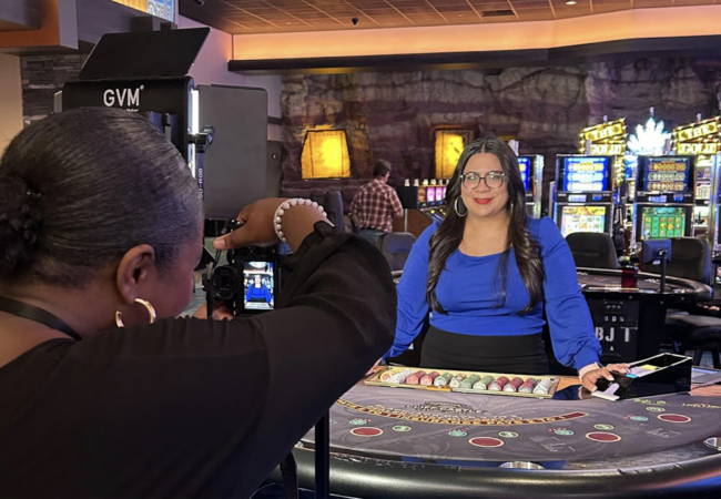 Someone taking a picture of a women working in a casino